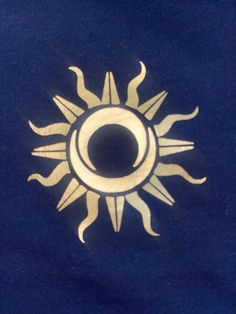 an image of a sun on a blue shirt