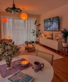 a living room filled with furniture and a flat screen tv mounted to the side of a wall