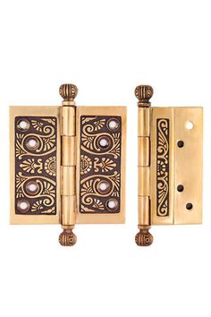 an antique brass plated door hinge with decorative designs on the front and sides