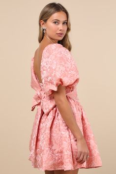 You'll be all sweetness in an adorably playful look like the Sister Jane Recital Pink Jacquard Floral Puff Sleeve Mini Dress! Lightweight woven fabric boasts a gorgeous floral jacquard design throughout as it shapes statement-making puff sleeves (with elastic at the cuffs) that frame a bodice with a square neckline and a low-cut back. Wide sashes tie at the back allow for a custom fit, atop a flaring skirt with trendy gathered side panels that lends a flirtatious finish. Hidden zipper at back. Fit: This garment fits true to size. Length: Mid-thigh. Size uk m/us 6 measures 33" from shoulder to hem. Bust: Great for any cup size. Waist: Fitted - very fitted at natural waist. Hip: Not Fitted - fuller skirt allows room for hips. Undergarments: May be worn with a strapless bra, adhesive bra, pet Cute Puff Dress, Pink Jacquard Evening Dress, Feminine Pink Puff Sleeve Dress For Wedding, Pink Jacquard Summer Dress, Pink Jacquard Dress For Wedding, Elegant Pink Puff Sleeve Dress With Floral Print, Puff Sleeve Dress Pattern, Sweet 17, Dress With Puff Sleeves