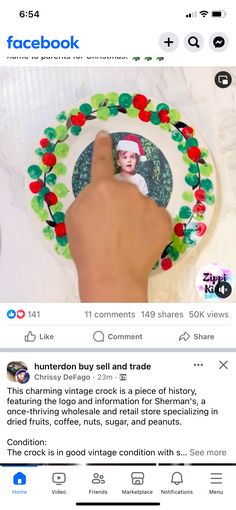 the facebook page has an image of a person's hand holding a christmas wreath