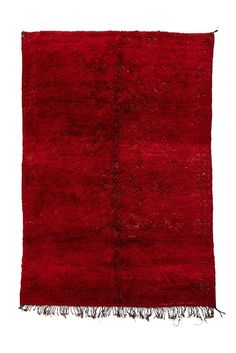 a red rug with fringes on it