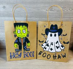 two paper bags with cartoon characters on them, one has a ghost and the other is a witch