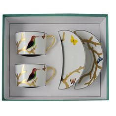 three cups and two saucers in a box with birds on them, one is yellow