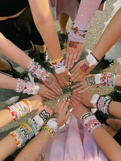 a group of people standing in a circle with their hands on top of each other