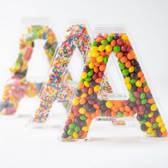 the letters are made out of candy and sprinkles