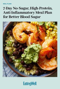 a bowl filled with shrimp, beans and guacamole on top of rice