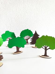 several cut out trees sitting on top of a table