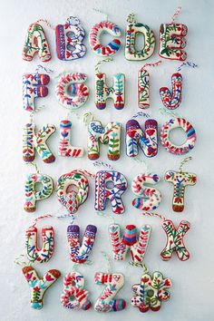 the letters are made up of different colors and shapes, including one that is decorated with candy canes