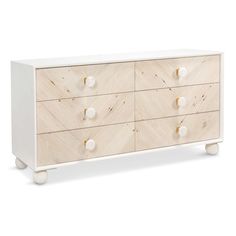 a white and wood dresser with four drawers