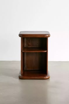 a wooden shelf sitting on top of a cement floor