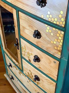 an old dresser has been painted with honeycombs and bees on the top drawer