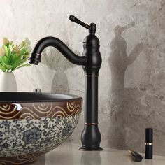 a black faucet sitting on top of a counter next to a bowl sink