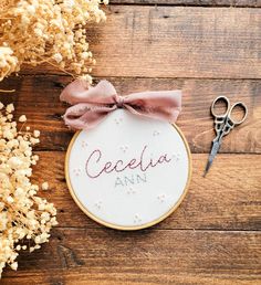 a cross stitch pattern with the word cecela ann on it next to scissors