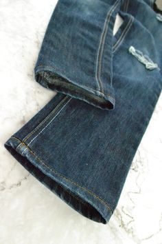 a pair of blue jeans sitting on top of a white counter