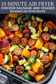 an air fryer filled with sausage and veggies