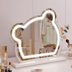 a vanity mirror with an image of a woman's face in the reflection on it