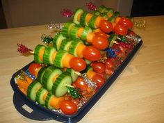 a tray filled with lots of veggies on top of a wooden table