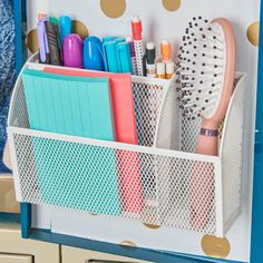 an organized desk organizer with polka dot wallpaper and gold dots on the walls behind it