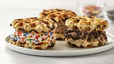 three waffles with chocolate and sprinkles on a plate