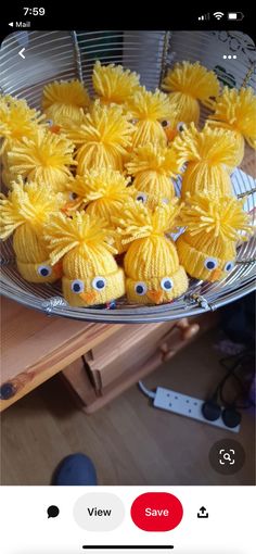 some yellow cupcakes with googly eyes in a bowl on a wooden table