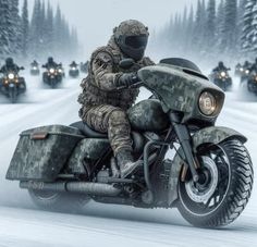 a man riding on the back of a motorcycle down a snow covered road next to trees