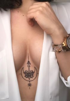 a woman with a tattoo on her chest is looking at the camera while wearing a white shirt