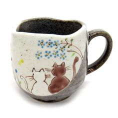 a cup with two cats painted on it