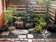 a small garden with rocks and plants in it