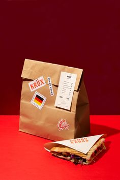 a brown paper bag sitting on top of a red table