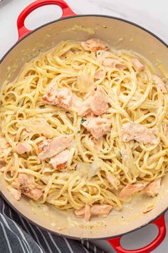 pasta with chicken and sauce in a red skillet