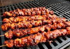 chicken skewers are being cooked on the grill