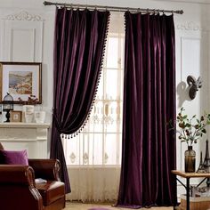 the living room is decorated with purple curtains