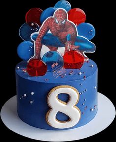 a birthday cake decorated with an image of spiderman on it's top and the number eight