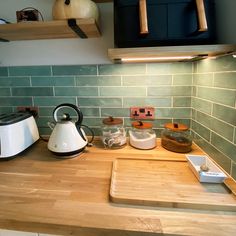 a tea kettle sitting on top of a wooden counter