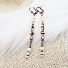 These earrings were handmade by me in the Art Deco style but with new (made to look old) components!  They would be great for your roaring 20's party - they are light and comfortable and stylish!  The earrings feature cream pearls - they are crystal cored high quality faux pearls, in various sizes, attached to unique art deco style brass metal connectors.  The connectors are hollow on the back.  The earrings end with brass lever back ear wires.  Total length is 3.25 inches with just 1/4 inch wid Clip-on Art Deco Jewelry For Formal Occasions, Vintage Pearl Drop Clip-on Earrings For Formal Occasions, Nickel-free Art Deco Dangle Earrings, Formal Art Deco Clip-on Earrings, Vintage Pearl Clip-on Earrings For Formal Occasions, Pearl Art, Roaring 1920s, Deco Earrings, Roaring 20's