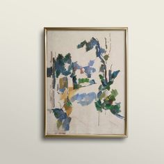 a hand is holding up a painting on a white wall with blue, green and yellow colors