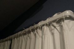 the curtain is pulled back from the wall