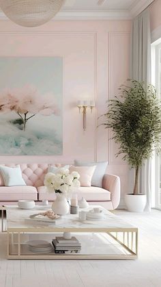 a living room with pink walls, white furniture and flowers on the coffee table in front of it