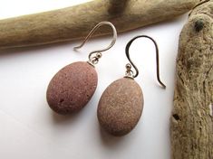 Sterling silver earrings with natural, carefully selected pink beach pebbles from a coastal nature park by the Baltic Sea. This item, just like everything by BalticSeasideDesign, is a unique handcrafted artefact, available in one piece only.These artistic stone earrings will add a characteristic detail to your outfit or make a priceless gift for any woman who appreciates the beauty of nature and the value of unique, handmade jewelry.Size: 35 mm (1.4 inches)You will receive them ready for gifting Beach Drop Earrings With Natural Stones, Handmade Oval Jewelry For Beach, Beach Pebble Art, Beach Theme Gifts, True Christmas, Sea Rocks, Pebble Jewelry, Beach Pebbles, Earrings Beach