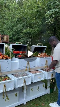 a man standing in front of an outdoor buffet