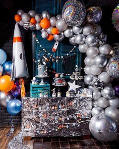 a space themed birthday party with balloons and decorations