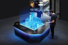 two men standing in front of a table that has an illuminated city on it and the caption reads, the world's first multi - user hologramm table