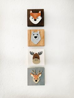 three wooden animal magnets mounted to the side of a wall