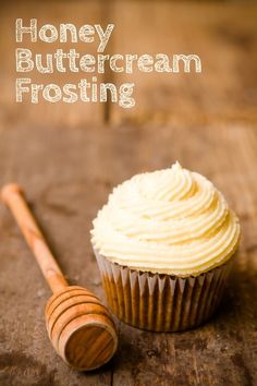 a honey buttercream frosting next to a wooden spoon