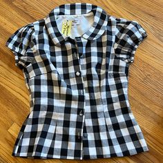 Women’s Black And White Buffalo Plaid Gingham Rockabilly Collared Blouse. Cute Round Buttons Down The Front. Elastic At Arms For Stretch. Purchased From Unique Vintage. New With Tags. Size Large. Approximately 15 Inches Laying Flat Across At Waist. Summer Picnic Fitted Blouse, Fitted Summer Blouse For Picnic, Fitted Casual Plaid Blouse, Fitted Short Sleeve Tops For Picnic, Plaid Fitted Blouse For Work, Fitted Plaid Blouse For Work, Cotton Short Sleeve Blouse For Picnic, Cotton Blouse With Short Sleeves For Picnic, Fitted Short Sleeve Tops In 1950s Style