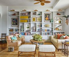 a living room filled with furniture and bookshelves covered in lots of bookcases