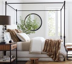 a bedroom with a canopy bed and pillows