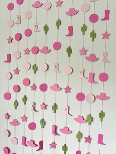 pink and green wall hangings with stars, cactuses, and moon shapes on them