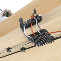 the wires are connected to each other in an electrical device on top of a wooden table